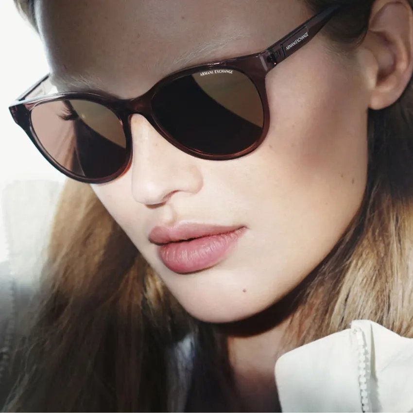 Close-up of a woman in round Armani Exchange sunglasses